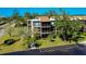 Three-story condo building with screened lanais and lush landscaping at 612 Bird Bay S Dr # 116, Venice, FL 34285
