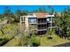 Three-story condo building with screened lanais and lush landscaping at 612 Bird Bay S Dr # 116, Venice, FL 34285