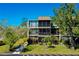 Three-story condo building with screened lanais and lush landscaping at 612 Bird Bay S Dr # 116, Venice, FL 34285