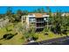 An aerial view of the condominium building exterior features balconies and parking at 612 Bird Bay S Dr # 116, Venice, FL 34285