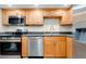 A well-equipped kitchen features stainless steel appliances and maple cabinets at 612 Bird Bay S Dr # 116, Venice, FL 34285