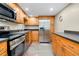 A well-equipped kitchen features stainless steel appliances and maple cabinets at 612 Bird Bay S Dr # 116, Venice, FL 34285