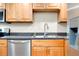 A well-equipped kitchen features stainless steel appliances and maple cabinets at 612 Bird Bay S Dr # 116, Venice, FL 34285