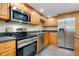 A well-equipped kitchen features stainless steel appliances and maple cabinets at 612 Bird Bay S Dr # 116, Venice, FL 34285