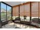 Relaxing sunroom with wicker chairs, floral cushions, and lots of natural light at 612 Bird Bay S Dr # 116, Venice, FL 34285