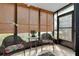 Inviting sunroom with wicker chairs, bamboo shades, and easy outdoor access at 612 Bird Bay S Dr # 116, Venice, FL 34285