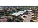 An aerial view of a single-Gathering home with a white roof, a circular driveway, and lush landscaping within a waterfront community at 618 Gladstone Ln, Holmes Beach, FL 34217