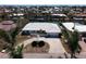 Aerial view of a waterfront property showcasing a tiled roof, circular driveway, and a canal at 618 Gladstone Ln, Holmes Beach, FL 34217