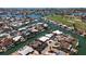 Aerial view of a coastal community with waterfront homes along canals and golf course nearby at 618 Gladstone Ln, Holmes Beach, FL 34217