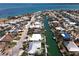A scenic aerial view of waterfront homes along a canal community with beautiful water views and a backdrop of stunning ocean vistas at 618 Gladstone Ln, Holmes Beach, FL 34217