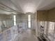 Bathroom awaiting renovation with tiled walls, mirror and window in view at 618 Gladstone Ln, Holmes Beach, FL 34217