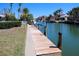 Scenic canal view from the dock with palms and luxury homes at 618 Gladstone Ln, Holmes Beach, FL 34217