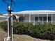 Exterior view of a screened lanai with white trim at 618 Gladstone Ln, Holmes Beach, FL 34217