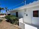 Exterior angle of a well-maintained white home with tropical landscaping at 618 Gladstone Ln, Holmes Beach, FL 34217