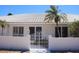 View of the property's entrance gate with manicured landscaping and white tiled roof at 618 Gladstone Ln, Holmes Beach, FL 34217