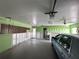 Spacious garage with car parked inside, cabinets, and exposed wall framing at 618 Gladstone Ln, Holmes Beach, FL 34217