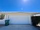Two-car garage with a white door and concrete driveway at 618 Gladstone Ln, Holmes Beach, FL 34217