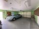 Spacious garage with cabinets, shelving, and a car parked inside at 618 Gladstone Ln, Holmes Beach, FL 34217