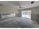 Open living room features studs and sliding doors to pool at 618 Gladstone Ln, Holmes Beach, FL 34217