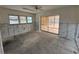 Sunroom or living room space with three windows and a sliding glass door to porch at 618 Gladstone Ln, Holmes Beach, FL 34217