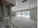 Living room with large window to pool features studs and bright light at 618 Gladstone Ln, Holmes Beach, FL 34217