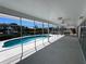 Enclosed lanai with views of the pool and the canal at 618 Gladstone Ln, Holmes Beach, FL 34217