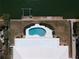 Aerial view of a kidney-shaped pool and dock in backyard at 618 Gladstone Ln, Holmes Beach, FL 34217