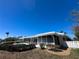 Rear of property with a screened-in porch and pool overlooking the water at 618 Gladstone Ln, Holmes Beach, FL 34217