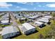 This aerial view showcases a vibrant community with well-maintained homes and community lake at 633 Cervina S Dr, Venice, FL 34285