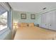 Cozy bedroom with pastel green walls, carpet flooring, and matching night stands at 633 Cervina S Dr, Venice, FL 34285