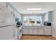 Bright kitchen features white appliances, blue accents and ample counter space for meal preparation at 633 Cervina S Dr, Venice, FL 34285