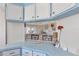 Open kitchen layout with blue and white cabinetry allows easy access to the adjacent living area at 633 Cervina S Dr, Venice, FL 34285