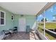 Enclosed lanai overlooking a peaceful pond, furnished with seating for relaxing and enjoying the view at 633 Cervina S Dr, Venice, FL 34285