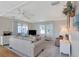 Cozy living room with comfortable furnishings, neutral paint, and access to the outdoor lanai through sliding doors at 633 Cervina S Dr, Venice, FL 34285