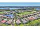 Expansive aerial view of a residential area with a golf course, lakes, and beautiful homes at 6540 The Masters Ave, Lakewood Ranch, FL 34202