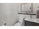 Cozy powder room featuring gray vanity, framed mirror, and modern fixtures at 6540 The Masters Ave, Lakewood Ranch, FL 34202