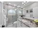 Sleek bathroom with modern fixtures, including a glass shower, marble counters, and ample vanity space at 6540 The Masters Ave, Lakewood Ranch, FL 34202