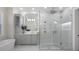 Modern bathroom featuring a walk-in shower with dual shower heads, sleek vanity, and contemporary fixtures at 6540 The Masters Ave, Lakewood Ranch, FL 34202