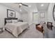 Tranquil bedroom featuring a comfortable bed, a reading chair, and a dark wood dresser at 6540 The Masters Ave, Lakewood Ranch, FL 34202