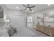 Comfortable bedroom with a plush bed, ample storage, and a view through the doorway to the rest of the house at 6540 The Masters Ave, Lakewood Ranch, FL 34202