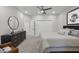 A contemporary bedroom with a ceiling fan and dark dresser against a neutral wall at 6540 The Masters Ave, Lakewood Ranch, FL 34202