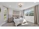 Sunlit bedroom featuring neutral colors, large windows, and elegant decor at 6540 The Masters Ave, Lakewood Ranch, FL 34202