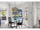 Breakfast nook with a glass table and a picturesque view of the pool and outdoor living space at 6540 The Masters Ave, Lakewood Ranch, FL 34202
