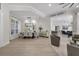 Open-concept dining area featuring modern chandelier, neutral tones, and light wood floors with lots of natural light at 6540 The Masters Ave, Lakewood Ranch, FL 34202