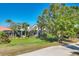 Beautifully landscaped yard with mature trees and manicured lawn at 6540 The Masters Ave, Lakewood Ranch, FL 34202