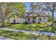 Beautiful exterior showcasing lush landscaping, a manicured lawn, and a charming facade at 6540 The Masters Ave, Lakewood Ranch, FL 34202