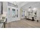 Grand foyer with a statement front door, hardwood floors, and elegant dining area at 6540 The Masters Ave, Lakewood Ranch, FL 34202