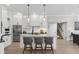 Modern white kitchen featuring a large island, stainless steel appliances, and open floor plan at 6540 The Masters Ave, Lakewood Ranch, FL 34202