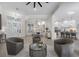 Bright living room with light wood floors, decorative lighting, and open floor plan to kitchen and dining at 6540 The Masters Ave, Lakewood Ranch, FL 34202
