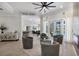 Elegant living room featuring hardwood floors, fireplace, and views of the pool area at 6540 The Masters Ave, Lakewood Ranch, FL 34202